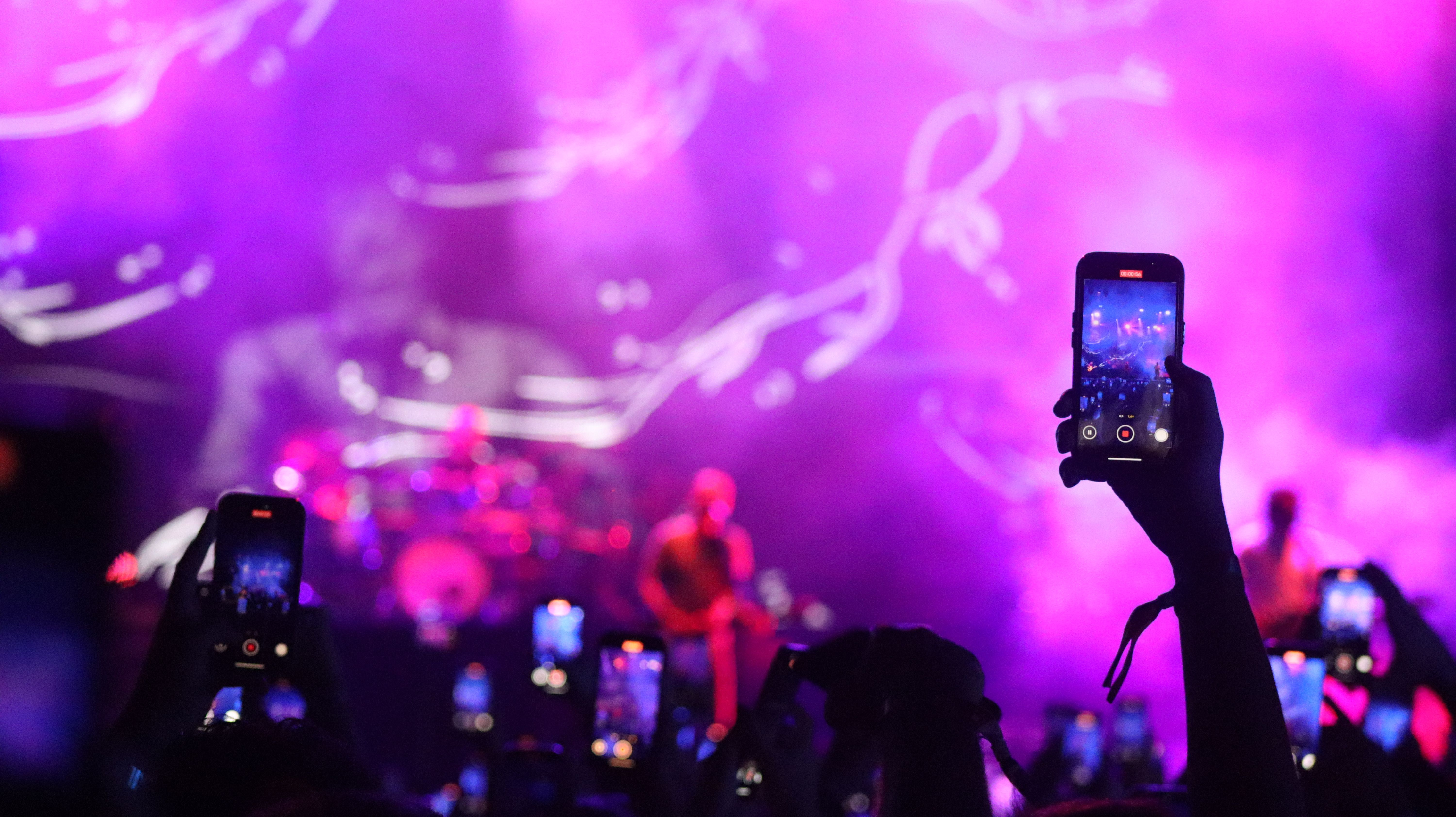 music venue with large crowd with mobile phones